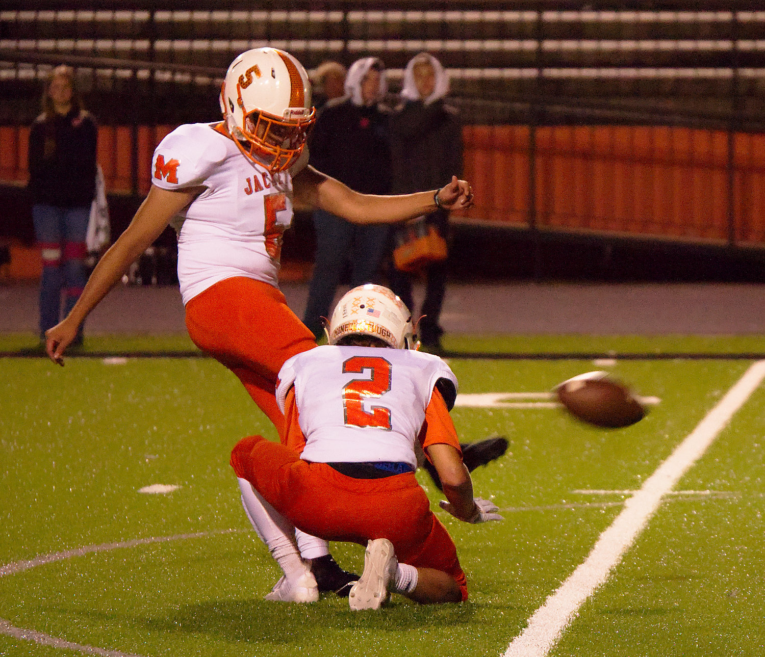 Mineola place kicker Gustavo Sanchez sends the winning kick on its way in Friday’s 17-14 victory over the Gladewater Bears. Dalton Rogers is the holder.